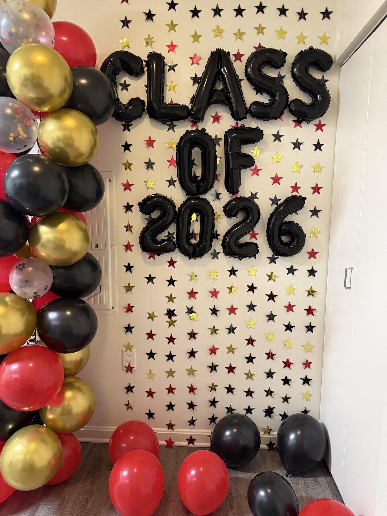 Red and gold balloon arch