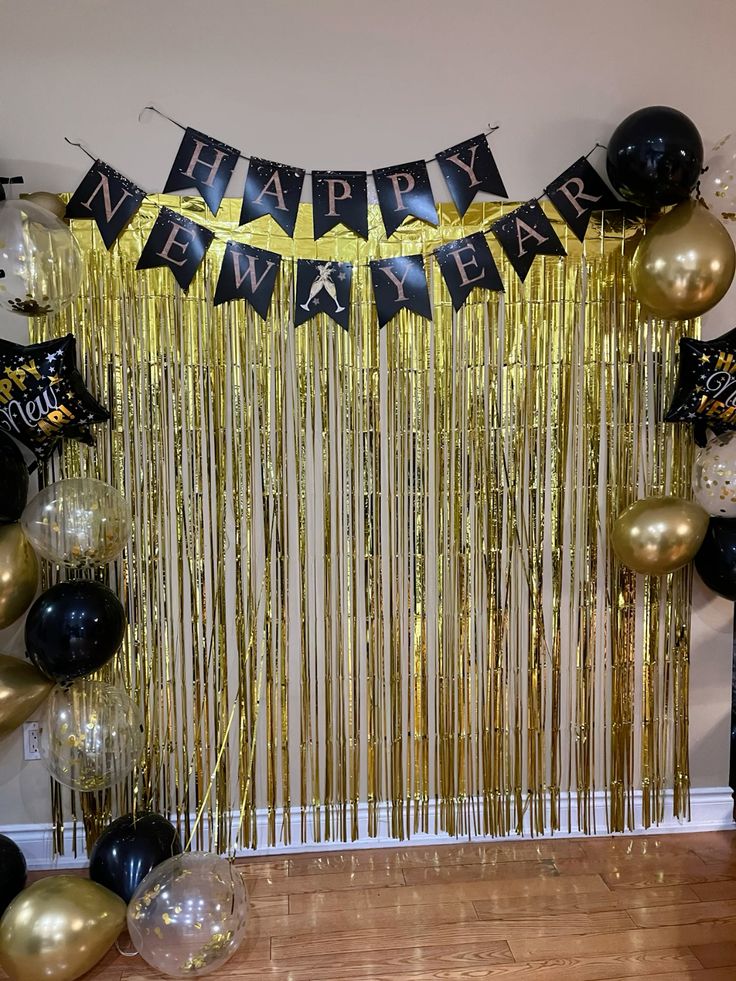 Happy New Year gold fringe backdrop with black and gold balloons